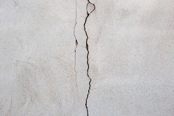 Close up of Diagonal Cracks in Cement Floor. Detail of cracked concrete surface.