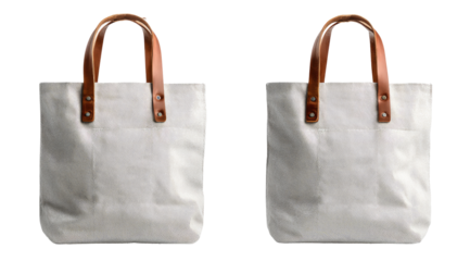 Two identical cream-colored canvas tote bags with tan leather handles