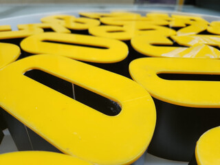 yellow and white plexiglass box letters
