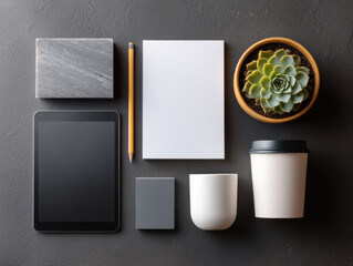 Modern home office desk showing tablet, coffee and succulent plant