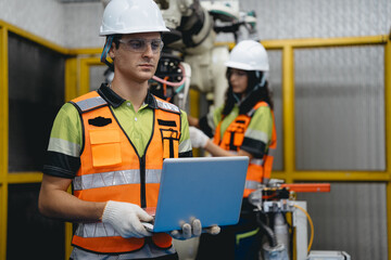 Smart Latino woman and male colleague working on AI technology in robotic electronic engineering...