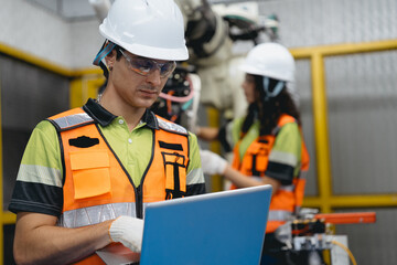 Smart Latino woman and male colleague working on AI technology in robotic electronic engineering...
