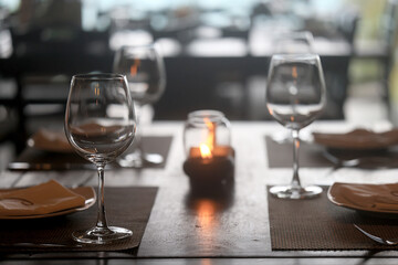 table setting in the restaurant, glasses and cutlery, a clean new table in the restaurant is waiting for guests, a free table