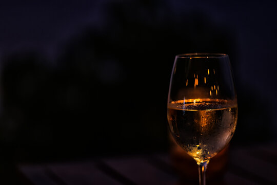 a glass of cold white wine and serving in the restaurant