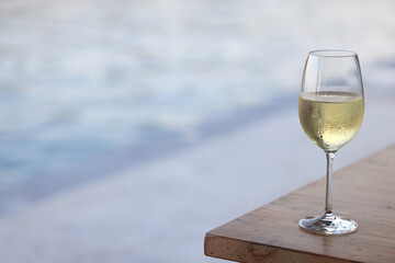 Wine glass close-up in real life, beautiful blurred background of the drink in the glass