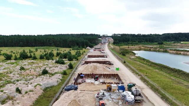 Heavy machinery in railway construction site, aerial view