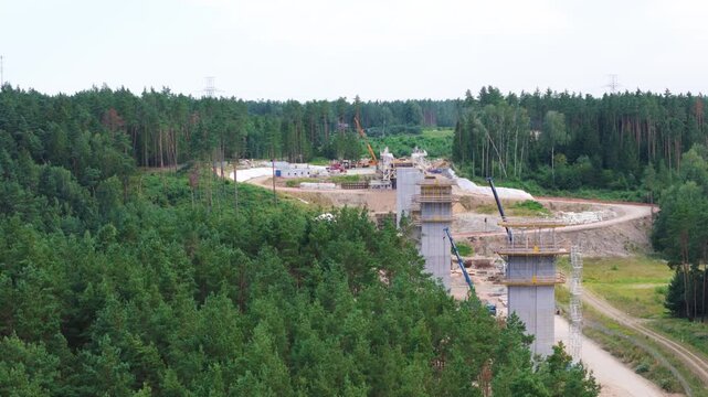Railway bridge construction site in forestry area, aerial low angle view