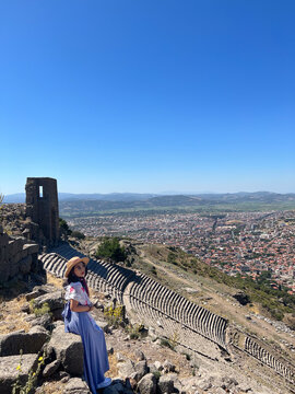 Lifestyle, Asian woman tourist take holiday for travel, View point Amphitheater theater in Acropolis of Pergamon or Pergamum is Ancient Greek City. Landmark of Tourism Turkiye, Bergama, Izmir, Turkey.