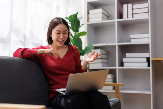 Young woman video conferencing on laptop at home