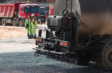 Heavy equipment for earthworks and landscaping. Close-up of a tanker truck with bitumen. Preparing for asphalt laying. Road construction.