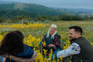 Fototapeta premium Three people enjoying themselves on a meadow in the hills
