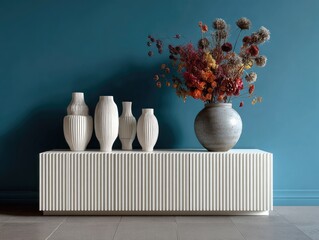 White console with vases and dried flowers