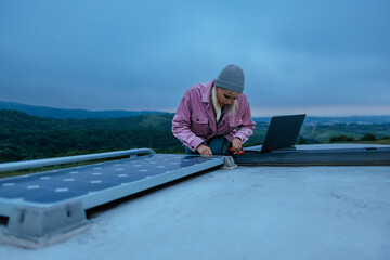 Woman installing a solar panel on the roof an RV