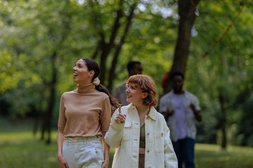 Fototapeta premium Two girls walking through a park