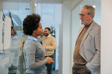Fototapeta premium Colleagues standing in the hallway talking