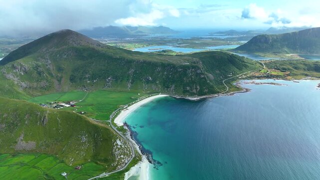 Experience the stunning natural beauty of Mannen mountain standing majestically over Haukland beach in Lofoten, Norway.