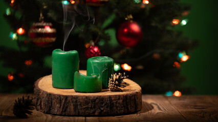 Green candles extinguish softly, sending wisps of smoke into the air. With a Christmas tree adorned with lights and ornaments, the cozy atmosphere invites warmth and holiday cheer.