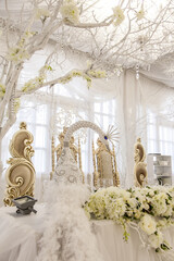 A beautifully arranged wedding table for the bride and groom features a stunning peacock theme