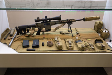 Modern automatic rifles with a set of equipment on the stand