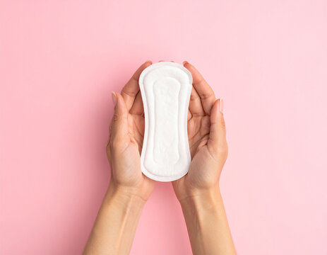 Hands holding a menstrual pad