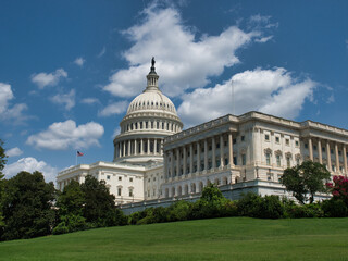 United States Capitol Building and Reflecting Pool - The U.S. Capitol Building and its reflecting pool on a sunny day with people walking on the lawn.