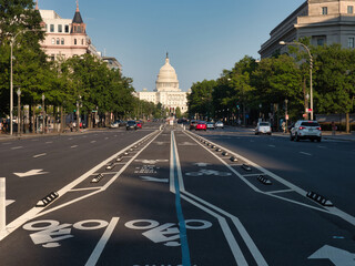 United States Capitol Building from the Street - The U.S. Capitol Building seen from a wide street with bike lanes and trees on a sunny day in Washington, D.C.