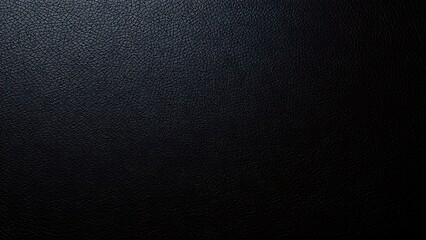 Close-up of black leather texture, highlighting luxurious material details with soft overhead lighting.