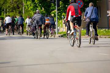 Group of cyclists on city road, street, asphalt