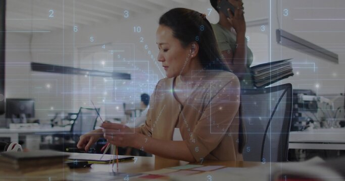Connecting colored network cables technician wiring laptop ports in open-plan office, with overlay
