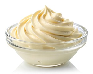 Creamy vanilla frosting swirled in a glass bowl isolated on white background