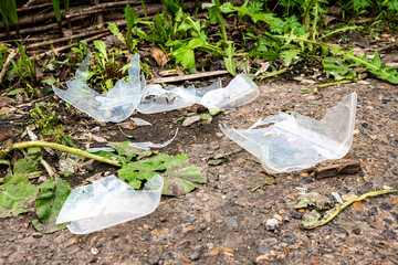 Broken plastic container fragments on ground surface