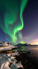 Naklejka premium Northern Lights over a frozen lake