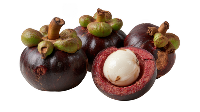 A close up of mangosteen fruits with one cut open revealing the white flesh on a black background
