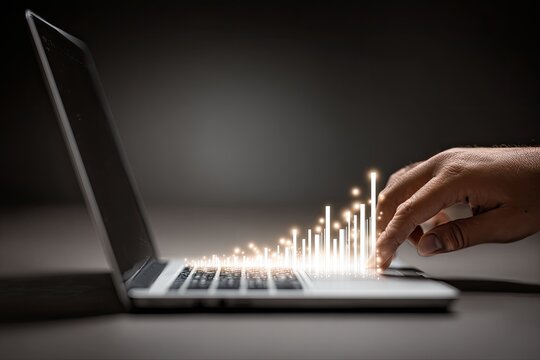 Hand over laptop keyboard, glowing light effect