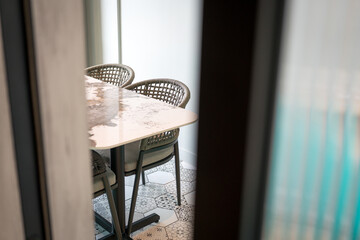 Wicker Chairs and Table Through Glass Door