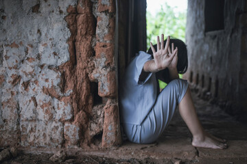 A woman raising her hands to stop violence against women and trafficking children. Abuse concept.