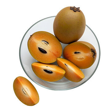 A whole and sliced sapodilla chiku fruit on a bowl clean transparent background