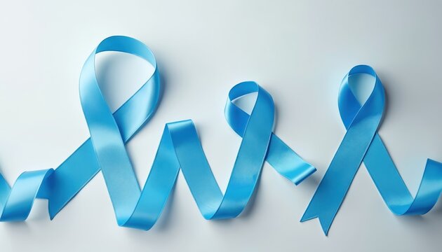 Three blue satin ribbons arranged on white background. Symbolic of awareness for Colon Cancer, Child Abuse, and World Diabetes Day. Shiny silk material represents support, care, and health campaigns.