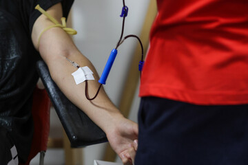 Shallow depth of field (selective focus) details with the hand of a man donating blood