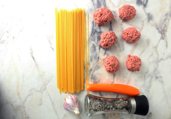 Concept of the recipe for cooking meatballs with spaghetti view from above