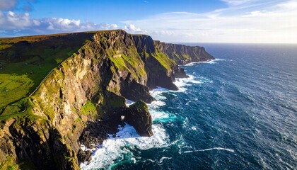 Aerial view of a coastal cliff with waves crashing below