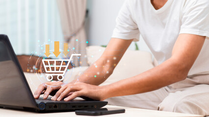 man using laptop with application online shopping platform and shopping cart icon during sitting at home, Application online shopping marketing platform concept