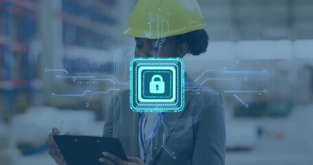 Engineer inspecting warehouse holding clipboard pen, activating digital lock icon for data security - Powered by Adobe