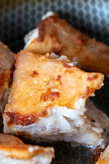 Sea bass fillets sizzling in a frying pan, showcasing golden crispy skin and tender white flesh, highlighting the culinary art of frying fish for delicious meals