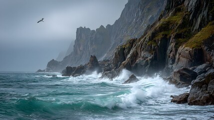 Cliffside ocean waves crash with frothy white foam beneath rugged mossy cliffs and cloudy skies.
