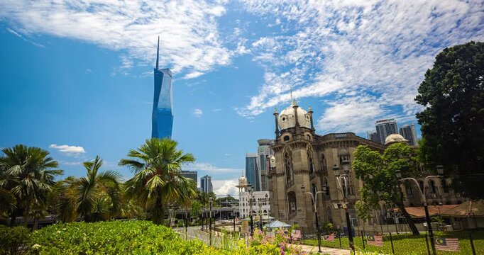 Kuala Lumpur, Malaysia &ndash; 16 September 2025: Merdeka 118 soars behind palm trees from national mosque park under a bright blue sky, Time lapse footage of the Second tallest building in the world