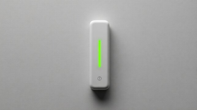 White rectangular device with green light