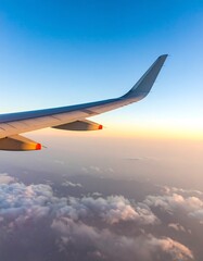Fototapeta premium Airplane wing over a colorful sunset view from above