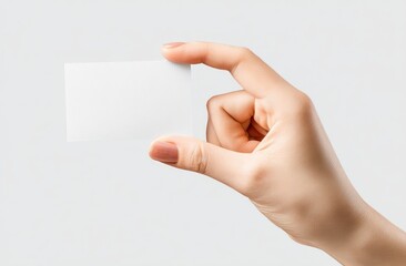 A woman's hand holds a blank white business card against a plain gray background