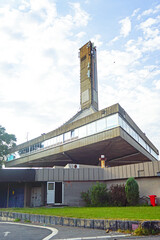 Belgrade 25 May Sportcenter: view of socialist modernist architecture with dramatic curved roofline and tower. Urban landscape photography showcasing iconic brutalist design in Serbia's capital